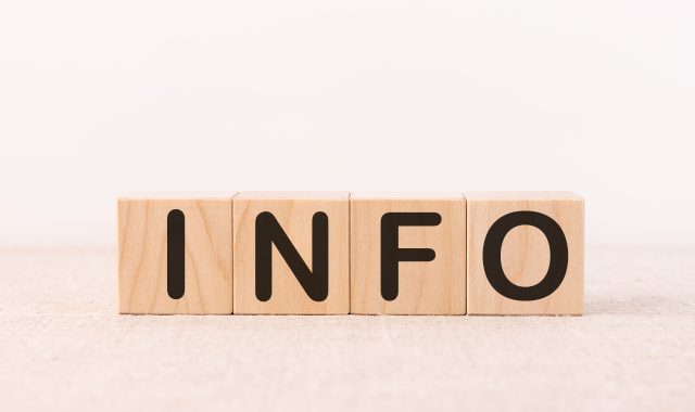 Info word concept written on wooden cubes on a light table and light background